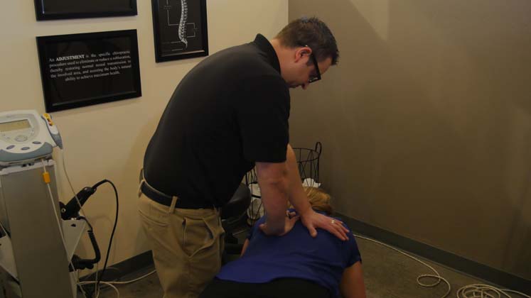 Dr. Doug preforming a chiropractic adjustment